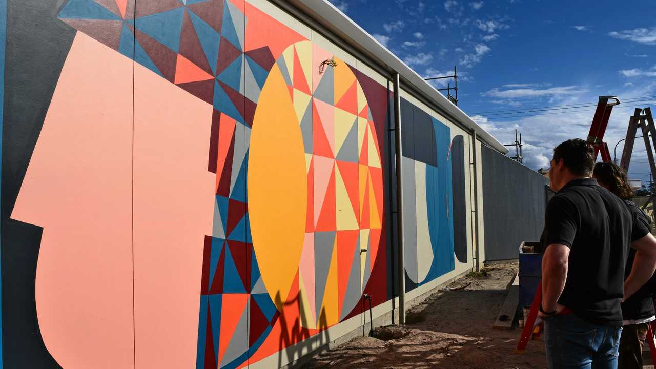 TARGO STREET ART: Orange Moose Dentistry owner, Hanno Venter and artist, Kyle Hughes-Odgers, enjoying the special and "almost finished" wall mural, ahead of the practice opening later this month. Picture: Rhylea Millar