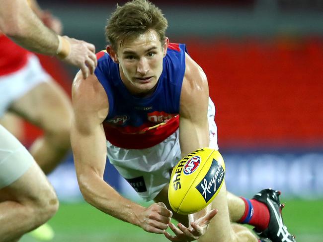 GOLD COAST, AUSTRALIA - JULY 26: Harris Andrews of the Lions makes a handpass during the round 8 AFL match between the Melbourne Demons and the Brisbane Lions at Metricon Stadium on July 26, 2020 in Gold Coast, Australia. (Photo by Jono Searle/AFL Photos/via Getty Images)