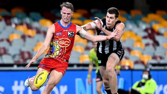 Jack Lukosius breaks away from Mason Cox on Monday night. Picture: Bradley Kanaris/Getty Images