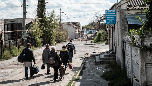 Residents evacuate Kupiansk, in the Kharkiv region, as clashes continued between Russian and Ukrainian forces on Monday. Picture: AFP