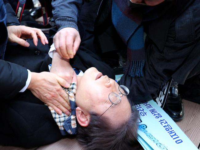 South Korea's opposition party leader Lee Jae-myung falls after being attacked by an unidentified man during his visit to Busan, South Korea, January 2, 2024.    Yonhap via REUTERS   THIS IMAGE HAS BEEN SUPPLIED BY A THIRD PARTY. NO RESALES. NO ARCHIVES. SOUTH KOREA OUT. NO COMMERCIAL OR EDITORIAL SALES IN SOUTH KOREA.     TPX IMAGES OF THE DAY