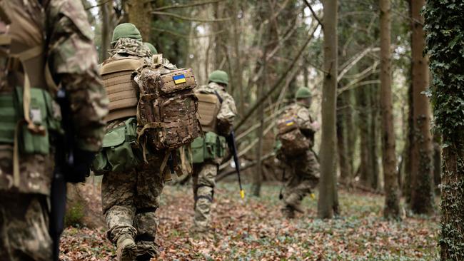 Recruits from Ukraine receive camouflage and concealment lessons from the British Army as part of field phase training delivered during Operation KUDU in the United Kingdom. Picture: Supplied by ADF