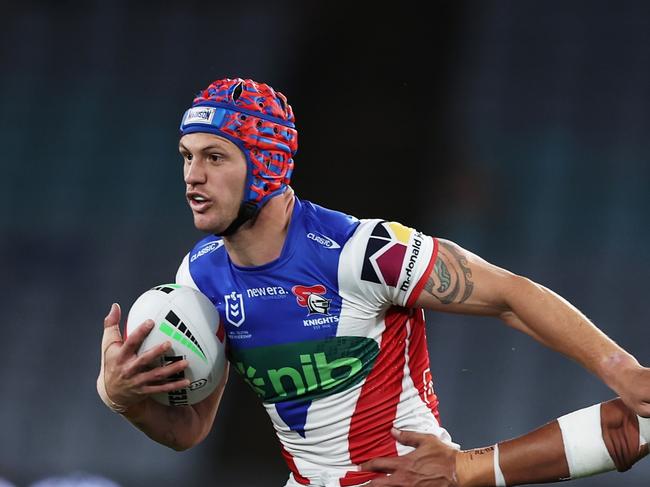 SYDNEY, AUSTRALIA - AUGUST 24:  Kalyn Ponga of the Knights takes on the defence during the round 25 NRL match between South Sydney Rabbitohs and Newcastle Knights at Accor Stadium, on August 24, 2024, in Sydney, Australia. (Photo by Matt King/Getty Images)