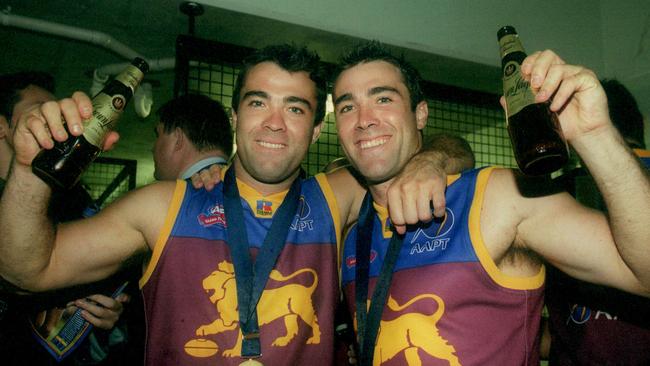 Brothers Chris and Brad Scott celebrate their 2002 premiership with the Brisbane Lions. Picture: Colleen Petch