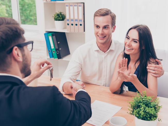 A couple discussing their home loan with a mortgage broker. Picture: iStock.