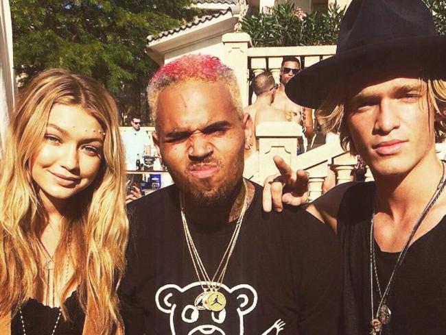 Still partying ... Chris Brown may be a new father but that didn’t stop him from hanging out with Cody Simpson and girlfriend Gigi Hadid at the Coachella Music festival in California. Picture: Supplied