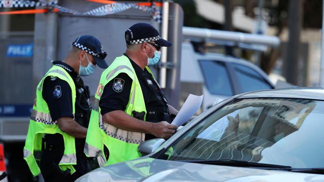 The army was set to arrive to assist police at the Queensland border. Queensland Police officers are pictured at the checkpoint in Griffith Street, Coolangatta. Picture: NIGEL HALLETT