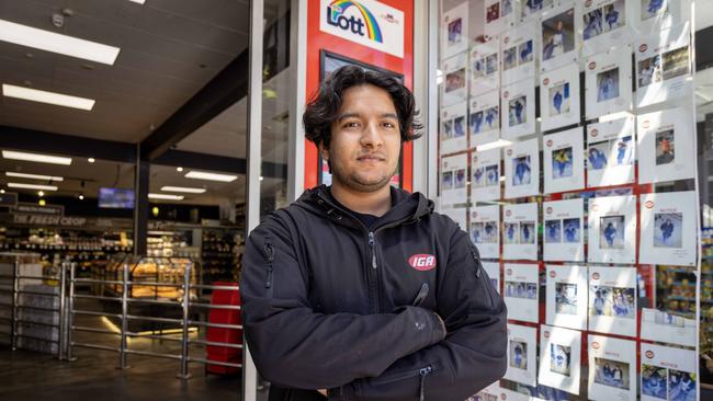 Gilbert Street IGA Manager Prajwol Risal stands in front of the Wall of shame. Picture: Kelly Barnes