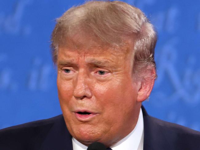 CLEVELAND, OHIO - SEPTEMBER 29: U.S. President Donald Trump takes out his mask during in the first presidential debate against Democratic presidential nominee Joe Biden at the Health Education Campus of Case Western Reserve University on September 29, 2020 in Cleveland, Ohio. This is the first of three planned debates between the two candidates in the lead up to the election on November 3.   Win McNamee/Getty Images/AFP == FOR NEWSPAPERS, INTERNET, TELCOS & TELEVISION USE ONLY ==