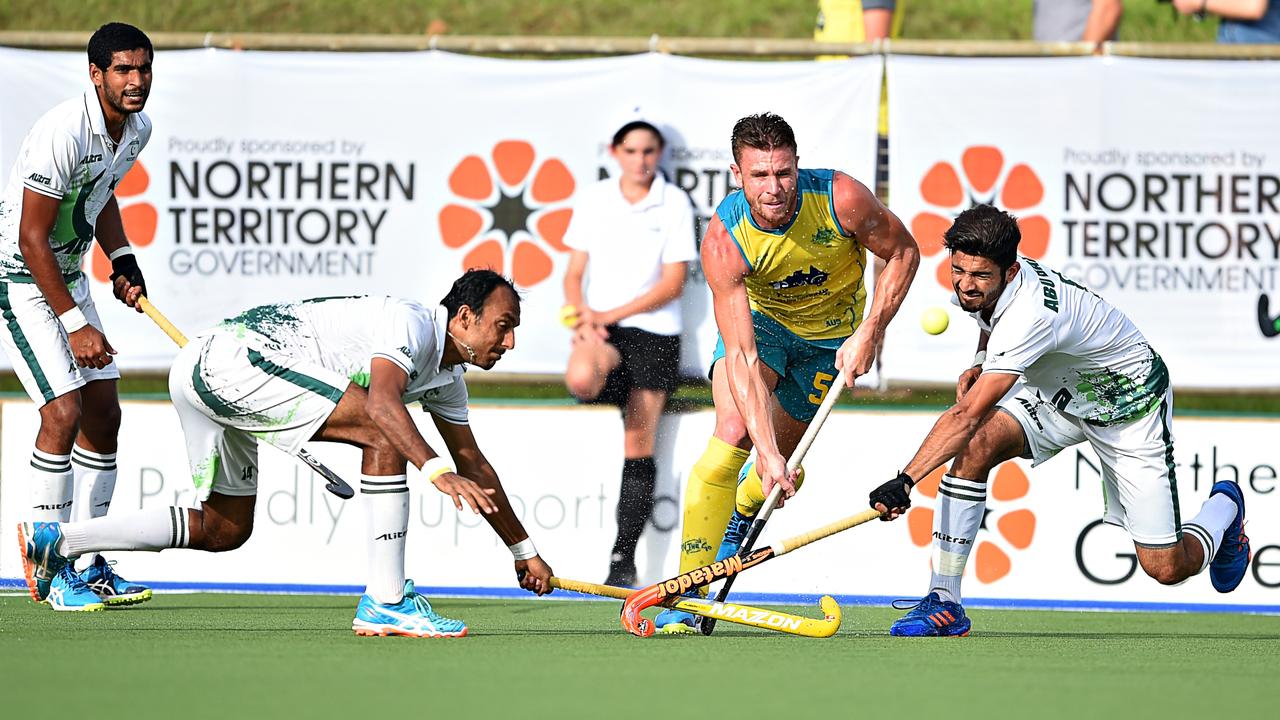 Australian player Tom Wickham is tackled by Pakistan players during an international match in Darwin, 2017.