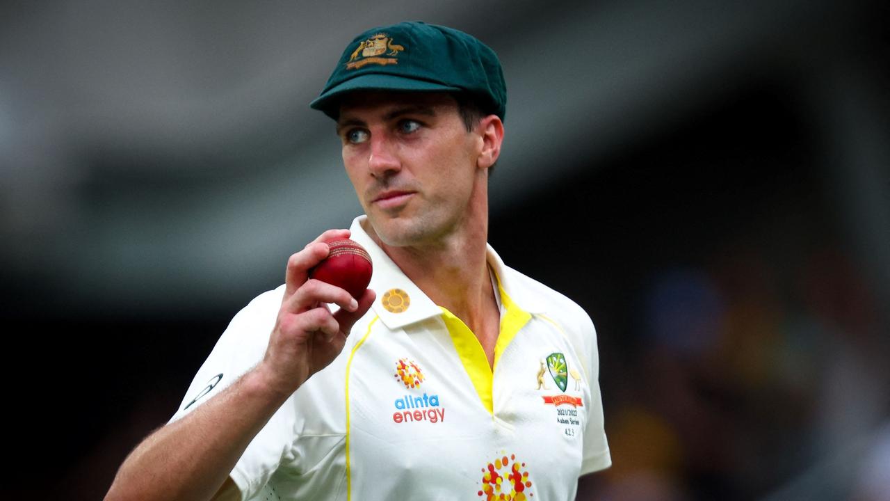 Australia's captain Pat Cummins salutes the crowd after claiming five wickets during day one of the first Ashes cricket Test match between England and Australia at the Gabba in Brisbane on December 8, 2021. (Photo by Patrick HAMILTON / AFP) / -- IMAGE RESTRICTED TO EDITORIAL USE - STRICTLY NO COMMERCIAL USE --