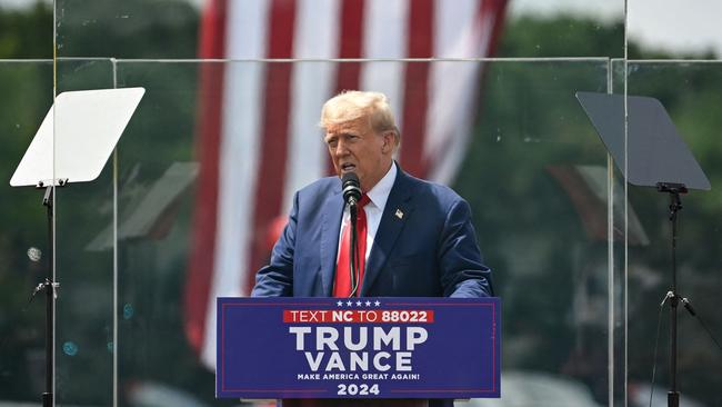 Former US President and Republican presidential candidate Donald Trump speaks behind bulletproof glass during a campaign rally at the North Carolina Aviation Museum &amp; Hall of Fame in Asheboro, North Carolina. Picture: Peter Zay/AFP