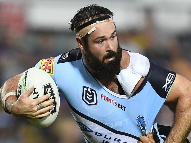 TOWNSVILLE, AUSTRALIA - MARCH 30: Aaron Woods of the Sharks is tackled by Matt Scott and  Jordan McLean of the Cowboys of the Cowboys during the round three NRL match between the North Queensland Cowboys and the Cronulla Sharks at 1300SMILES Stadium on March 30, 2019 in Townsville, Australia. (Photo by Ian Hitchcock/Getty Images)