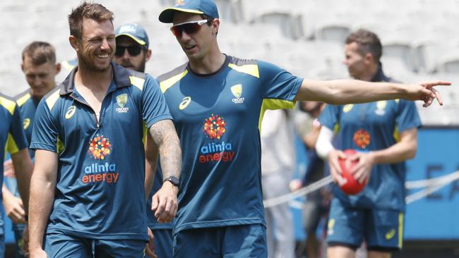 Australian quicks James Pattinson and Pat Cummins have a conversation during a nets session at the MCG on Monday. Picture: Getty Images