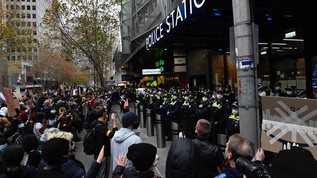 Protesters face off against police at Melbourne East Police Station. Picture: Jason Edwards