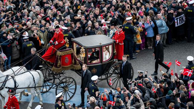 King Frederik X and Queen Mary ride in a coach past the the crowd of wellwishers back to Amalienborg Palace. Picture: AFP.