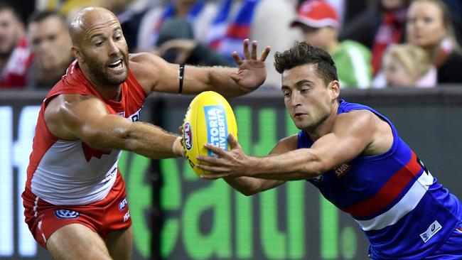 Luke Dahlhaus of the Bulldogs and Jarrad McVeigh of the Swans contest for the ball. Pic: AAP