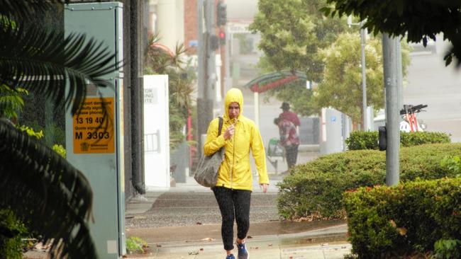 A woman walks through the rain in Townsville. Picture: Blair Jackson