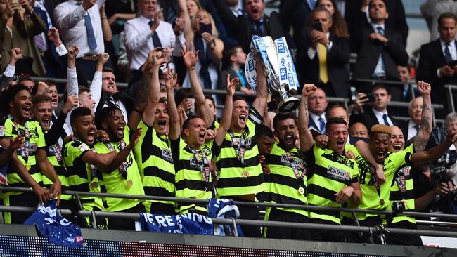 Huddersfield Town's players lift the Championship Playoff trophy.