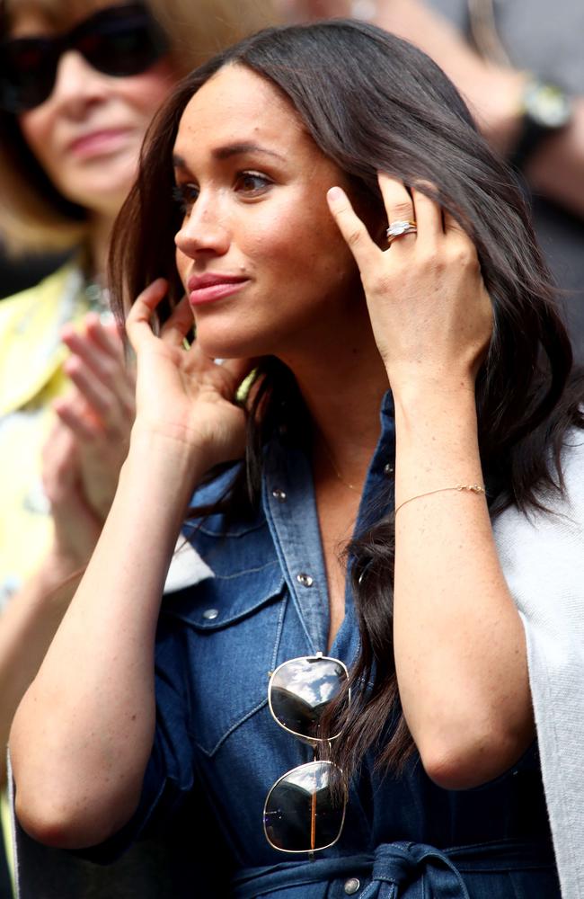 Meghan rocks a denim dress as she watches her pal Serena Williams.