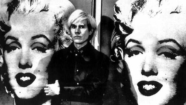 Pop artist Andy Warhol, 1929-1987, shown in 1971 file photo standing in front of his double portrait of actor Marilyn Monroe at London's Tate Gallery. AP Photo. General / Art Historical