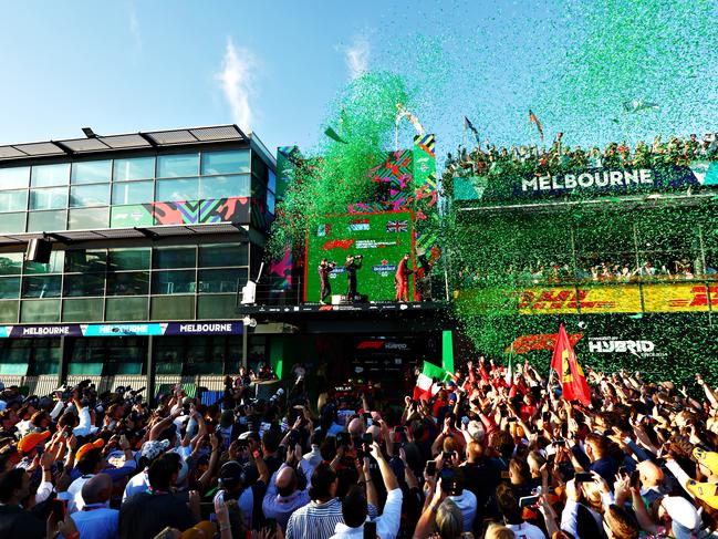 MELBOURNE, AUSTRALIA - APRIL 10: Race winner Charles Leclerc of Monaco and Ferrari, Second placed Sergio Perez of Mexico and Oracle Red Bull Racing and Third placed George Russell of Great Britain and Mercedes celebrate on the podium during the F1 Grand Prix of Australia at Melbourne Grand Prix Circuit on April 10, 2022 in Melbourne, Australia. (Photo by Mark Thompson/Getty Images)