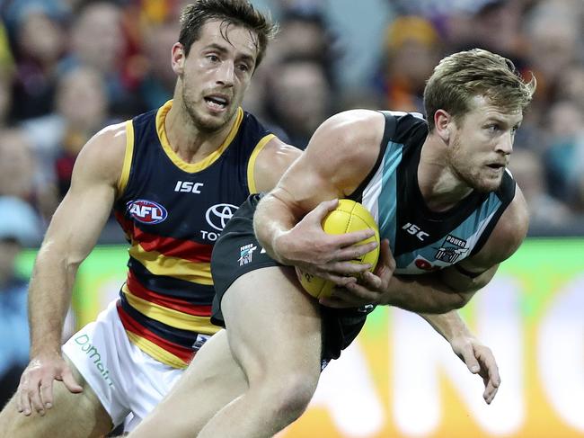 12/05/18 - AFL - Round 8, SHOWDOWN - Port Adelaide v Adelaide Crows at Adelaide Oval. Tom Jonas tries to break away from Richard Douglas. Picture SARAH REED