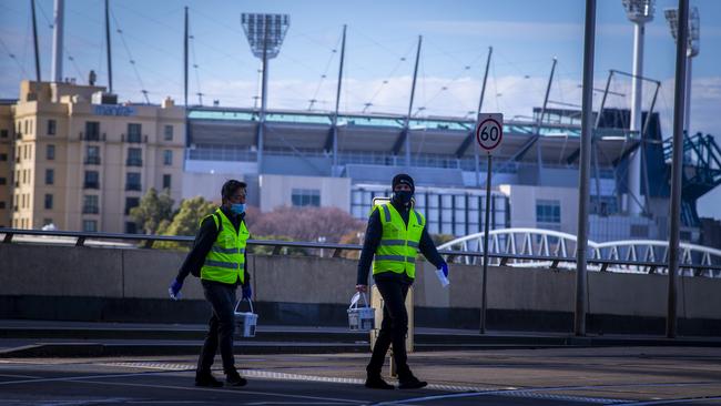 Street cleaners walking the empty streets of Melbourne. Picture: NCA NewsWire/Wayne Taylor