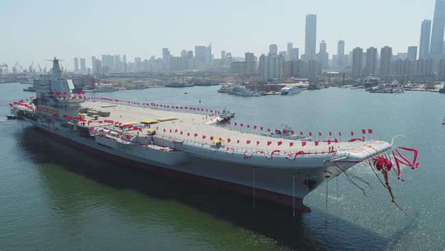 A newly-built aircraft carrier is transferred from dry dock into the water earlier this year at a launch ceremony at a shipyard in Dalian in northeastern China's Liaoning Province. Picture: Xinhua / AP