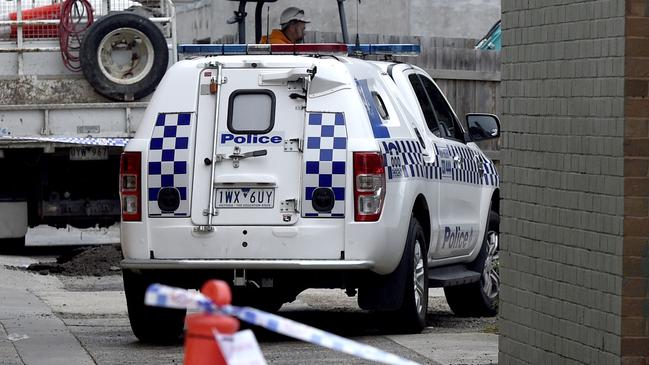 Police guard the rear laneway behind the Bentleigh Smoke Shop Convenience Store on Centre Road Bentleigh after a suspicious fire overnight. Picture: Andrew Henshaw