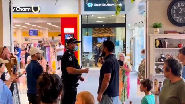 Cafe patrons surround police attending The Vintage Apron cafe at Capalaba. Picture: Supplied