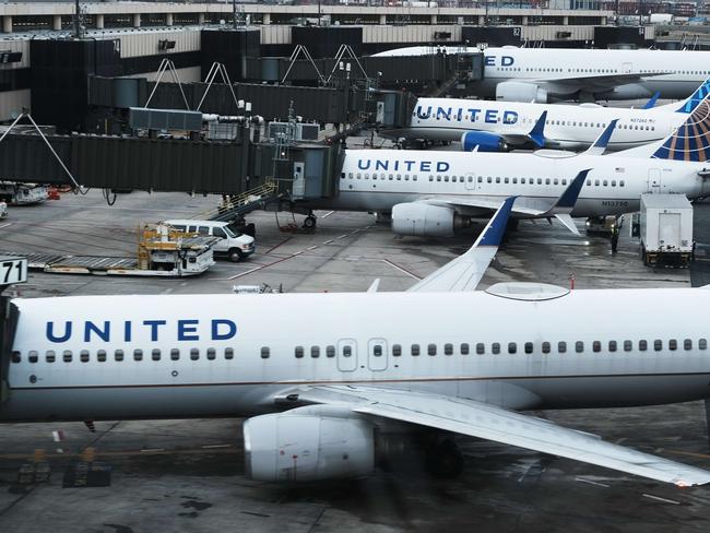 NEWARK, NEW JERSEY - NOVEMBER 30: United Airlines planes sit on the runway at Newark Liberty International Airport on November 30, 2021 in Newark, New Jersey. The United States, and a growing list of other countries, has restricted flights from southern African countries due to the detection of the COVID-19 Omicron variant last week in South Africa. Stocks in the travel and airline industry have fallen in recent days as fears grow over the spread and severity of the variant.   Spencer Platt/Getty Images/AFP == FOR NEWSPAPERS, INTERNET, TELCOS & TELEVISION USE ONLY ==