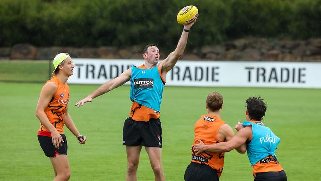 Bombers ruckman Todd Goldstein taps the ball down during a drill on Saturday. Picture: Ian Currie