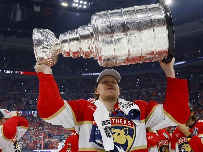 SUNRISE, FLORIDA - JUNE 24: Niko Mikkola #77 of the Florida Panthers hoist the cup after Florida's 2-1 victory against the Edmonton Oilers in Game Seven of the 2024 Stanley Cup Final at Amerant Bank Arena on June 24, 2024 in Sunrise, Florida. (Photo by Bruce Bennett/Getty Images)