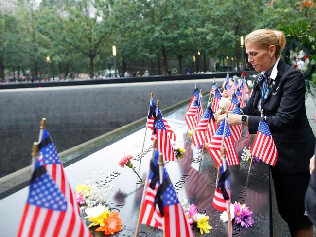 Sara Nelson, International President of the Association of Flight Attendants, places a flower on the 9/11 memorial pool. Picture: AFP