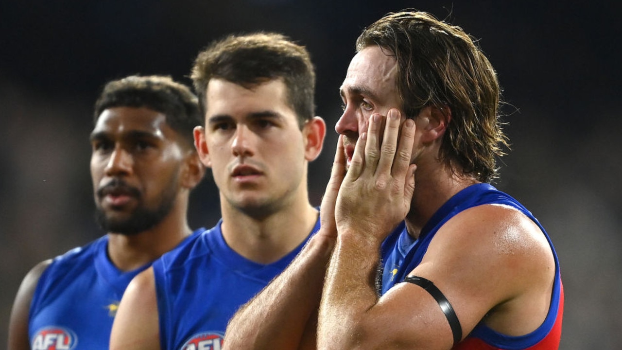 MELBOURNE, AUSTRALIA - SEPTEMBER 16: Keidean Coleman, Brandon Starcevich and Rhys Mathieson of the Lions look dejected after losing the AFL First Preliminary match between the Geelong Cats and the Brisbane Lions at Melbourne Cricket Ground on September 16, 2022 in Melbourne, Australia. (Photo by Quinn Rooney/Getty Images)