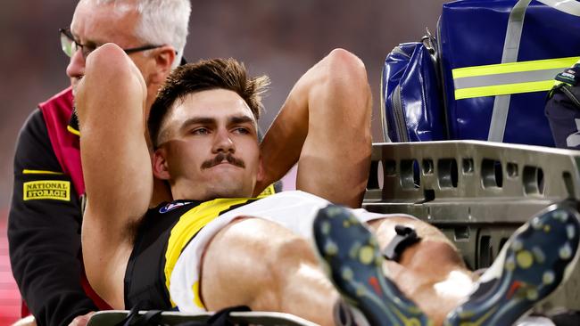 Josh Gibcus was carted off the MCG. (Photo by Dylan Burns/AFL Photos via Getty Images)