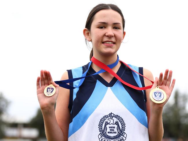 MELBOURNE, AUSTRALIA - AUGUST 10:  Neave Dickson of Sacred Heart College Geelong poses with her best on ground and winners medal following the 2023 Herald Sun Shield Intermediate Girls Grand Final match between Sacred Heart College Geelong and Carey Grammar at Trevor Barker Oval on August 10, 2023 in Melbourne, Australia. (Photo by Graham Denholm/AFL Photos via Getty Images)