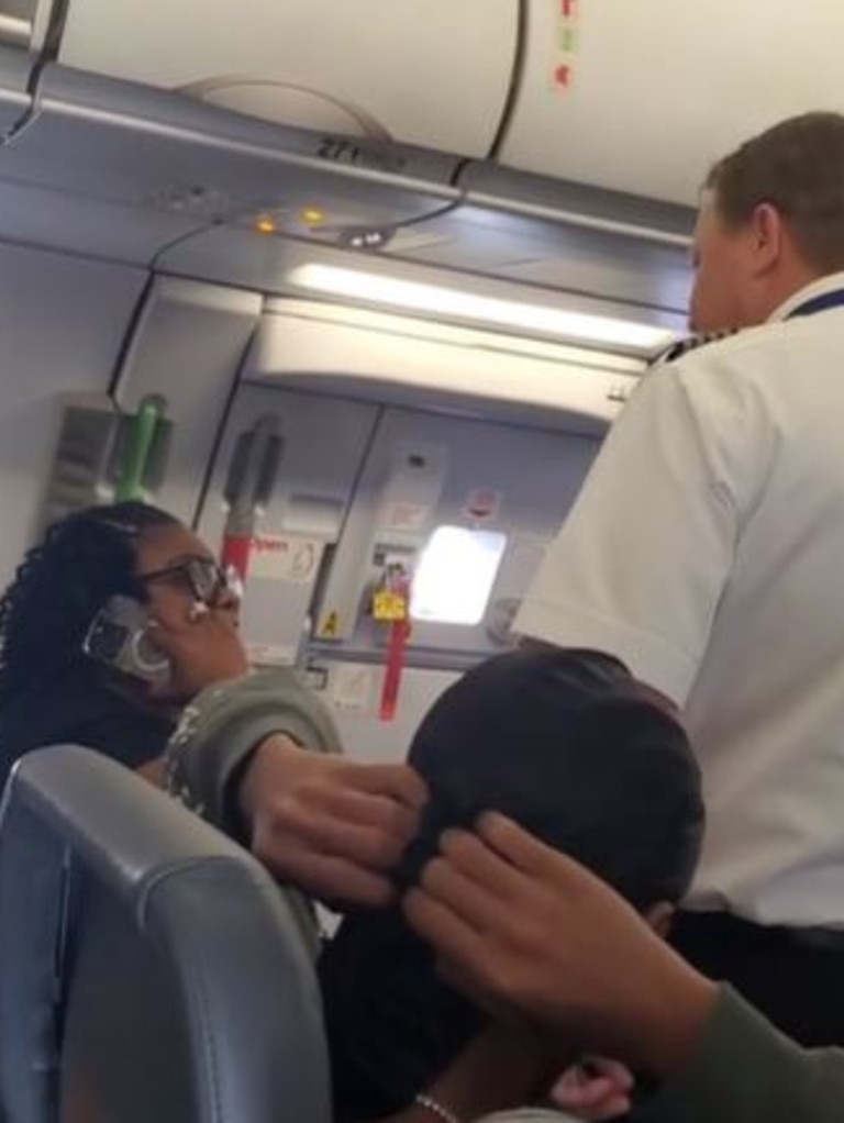 The pilot tried to reason with the woman to step off the plane.