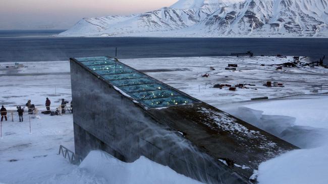Snow blows off the Svalbard Global Seed Vault before being inaugurated at sunrise, Tuesday, Feb. 26, 2008. The "doomsday" seed vault built to protect millions of food crops from climate change, wars and natural disasters opened Tuesday deep within an Arctic mountain in the remote Norwegian archipelago of Svalbard. (AP Photo/John McConnico)