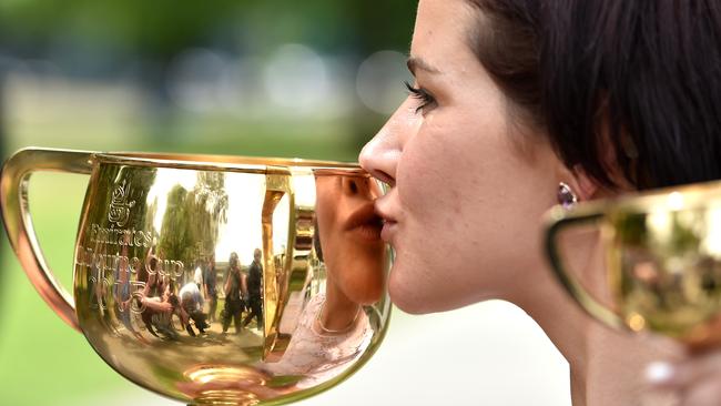 Melbourne Cup winning Jockey Michelle Payne kisses the cup after a press conference in Melbourne Wednesday Nov. 4, 2015. (AAP Image/Tracey Nearmy) NO ARCHIVING