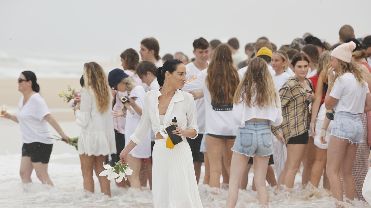 Family and friends of 16-year-old alleged stabbing victim Balin Stewart gather to pay tribute on his home beach at Buddina. Picture: Lachie Millard