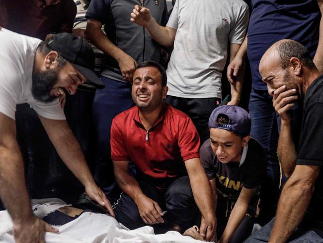 Family members and relatives mourn over the bodies of Palestinian militants killed in the latest infiltration operation into Israel. Picture: AFP