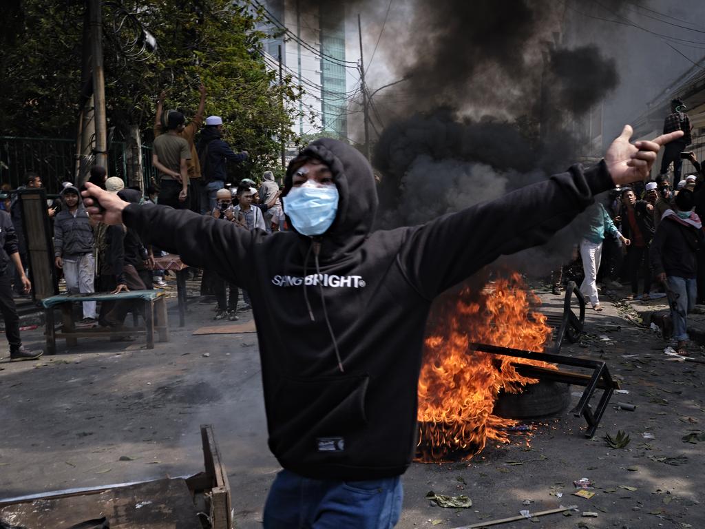 An Indonesian man taunts police during a clash on Wednesday. Picture: Ed Wray/Getty Images