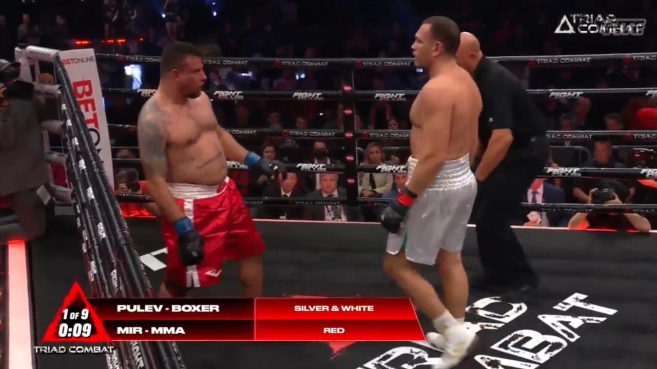 Frank Mir wobbles on his feet as Kubrat Pulev waits for the ref to step in.