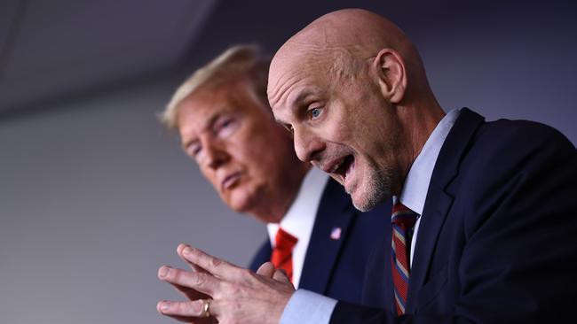 US President Donald Trump listens to FDA Commissioner Stephen Hahn. PIcture: AFP