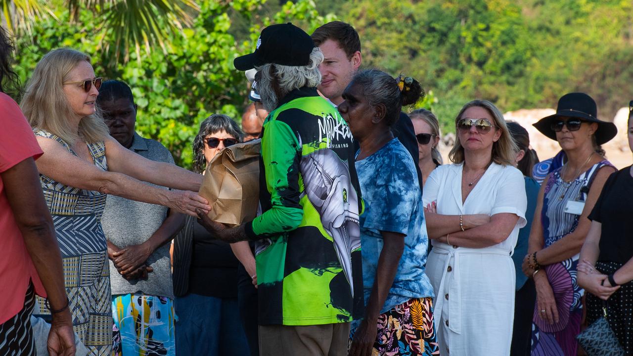 NT Coroner Elisabeth Armitage hands the belongings of Ngeygo Ragurrk to her father Tommy Madjalgaidj at a ceremony at Mindil Beach, where on December 23 2019 the 40-year-old was killed by her partner Garsek Nawirridj. Picture: Pema Tamang Pakhrin