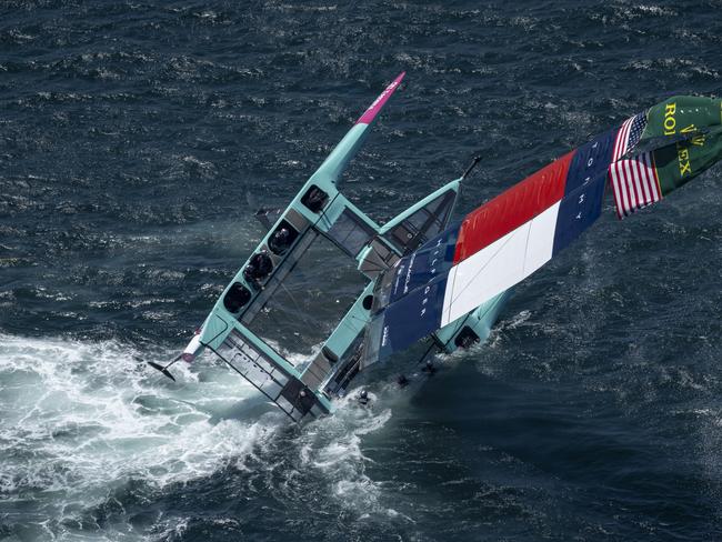 The USA SailGP Team F50 catamaran is recovered by a support crew after it capsized while being towed on to the race area for a practice session Picture: SailGP