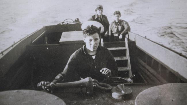 Nevin Phillips pilots a landing craft during the war.