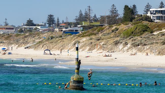 Swimmers jump from Bell at Cottesloe Beach. Photo: Paul Kane/Getty Images.